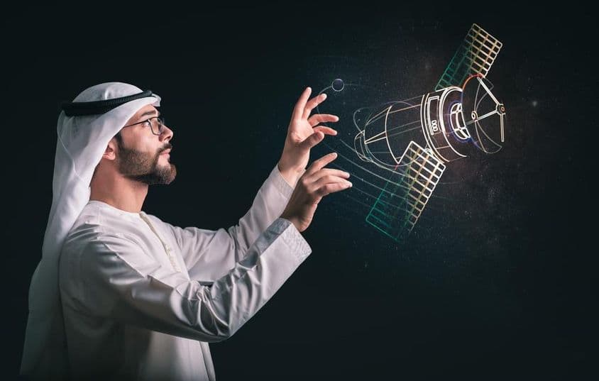 穆斯林男子在投影的卫星前面