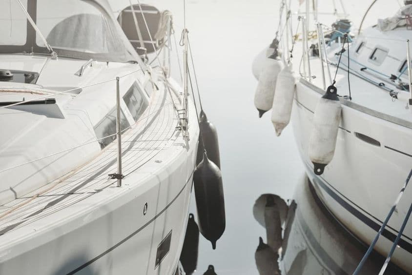 一艘白色现代风格的帆船停靠在码头。