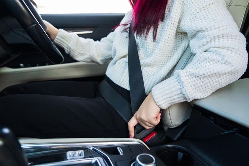 女性司机系好她的安全带。